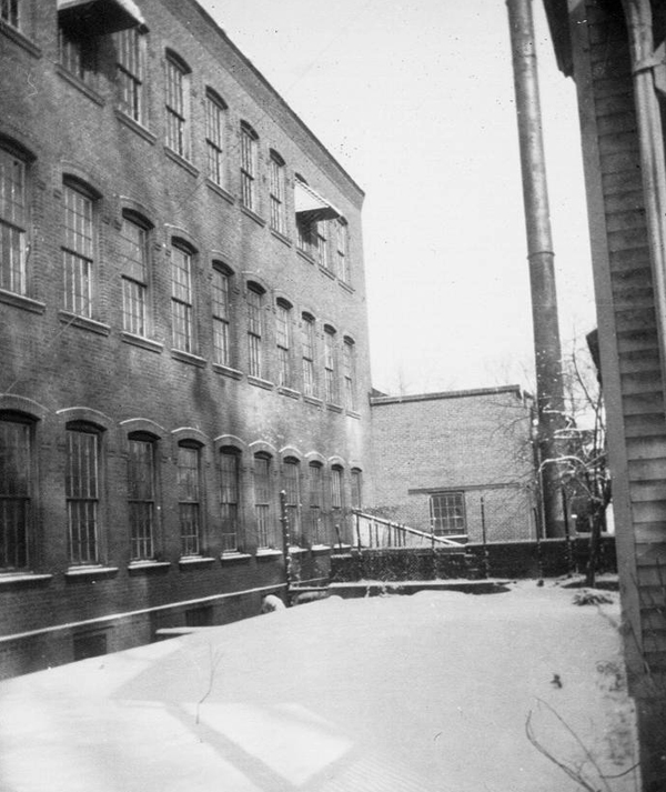 Auburn Button Works and Logan Silk Mills Photo taken in 1952 showing east side of factory with 90ft boiler chimney.